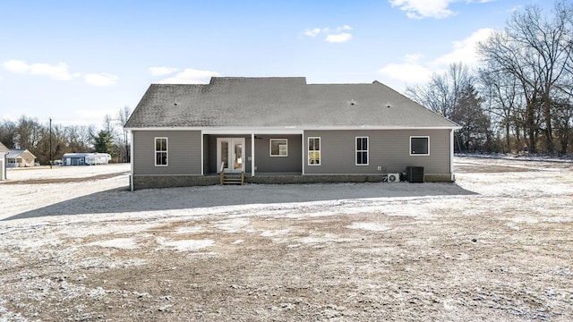 rear view of house featuring central AC