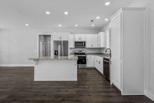 kitchen with sink, a center island, white cabinets, and appliances with stainless steel finishes