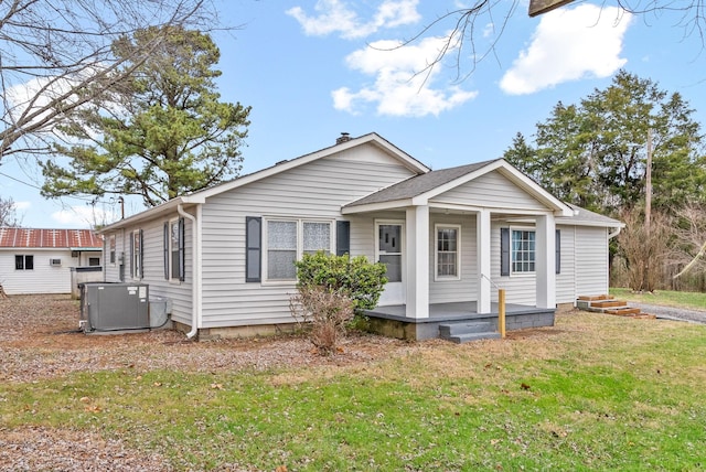 view of front of house with a front yard and cooling unit