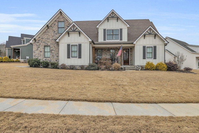 view of front of house with covered porch and a front lawn