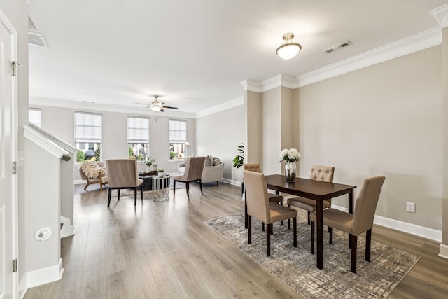 dining area with hardwood / wood-style flooring, ceiling fan, and ornamental molding