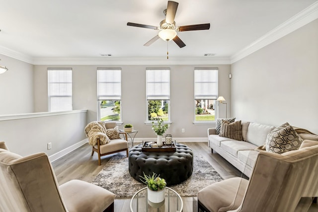 living room featuring light hardwood / wood-style floors, crown molding, and ceiling fan