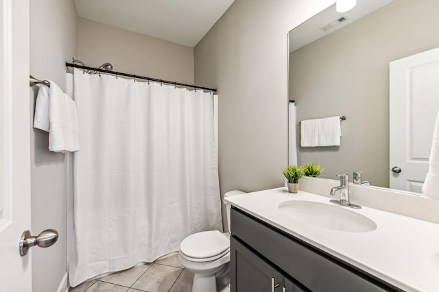 bathroom featuring toilet, vanity, and tile patterned flooring