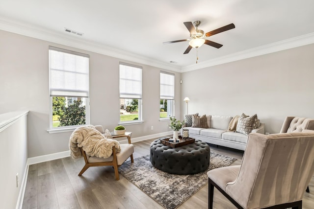 living room with ceiling fan, hardwood / wood-style floors, and crown molding