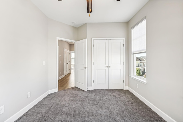 unfurnished bedroom with a closet, ceiling fan, and carpet flooring