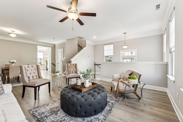 living room featuring light wood-type flooring and ornamental molding