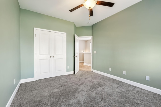 unfurnished bedroom with carpet floors, a closet, and ceiling fan