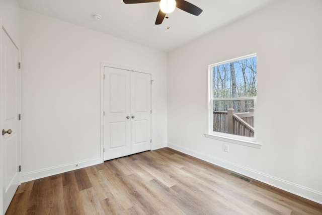 unfurnished bedroom featuring a closet, ceiling fan, and light wood-type flooring