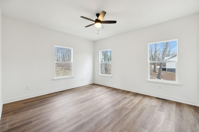 spare room featuring ceiling fan and light hardwood / wood-style flooring