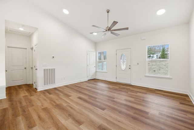 entrance foyer featuring ceiling fan, vaulted ceiling, and light wood-type flooring