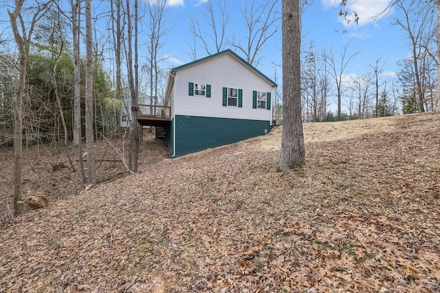 view of property exterior with a deck