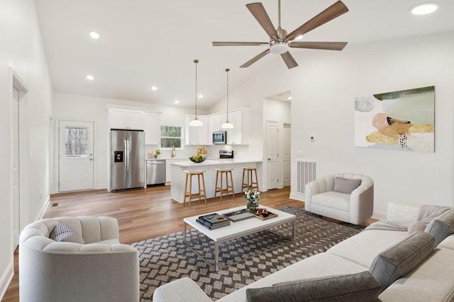 1067 Bald Eagle Dr, Kingston Springs, TN 37082 - living room with ceiling fan, recessed lighting, baseboards, light wood-type flooring, and high vaulted ceiling