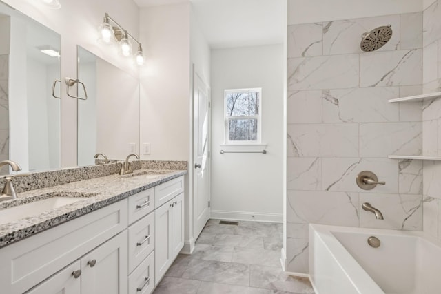 bathroom featuring vanity and tiled shower / bath combo