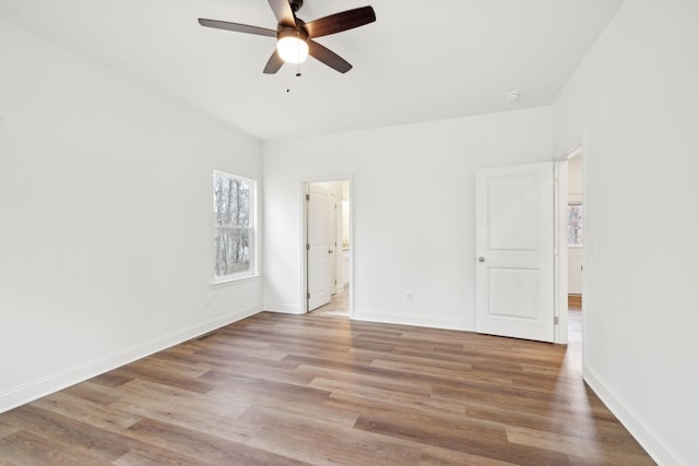 unfurnished bedroom with light hardwood / wood-style flooring, connected bathroom, and ceiling fan