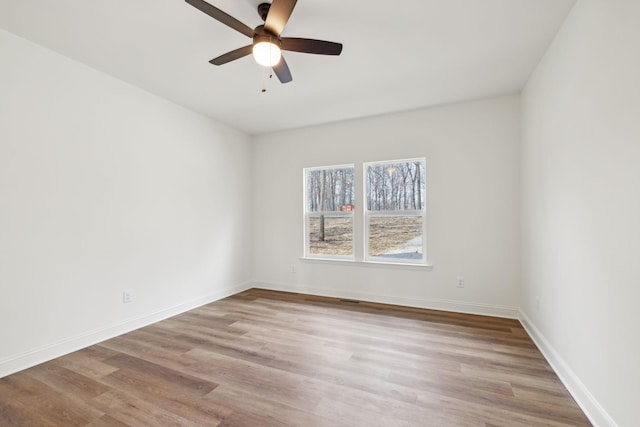 empty room with ceiling fan and light wood-type flooring