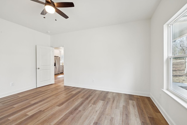 unfurnished room with light hardwood / wood-style floors and ceiling fan