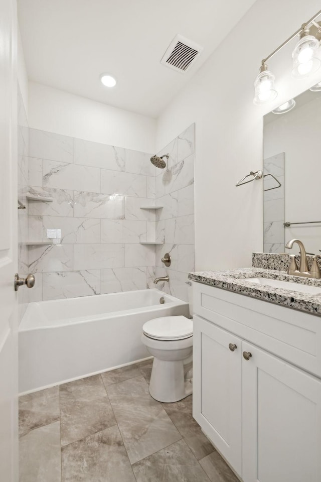 full bathroom featuring tiled shower / bath combo, toilet, and vanity