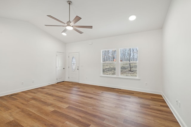 unfurnished room featuring light wood-type flooring, vaulted ceiling, and ceiling fan