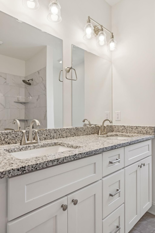 bathroom featuring vanity and tiled shower