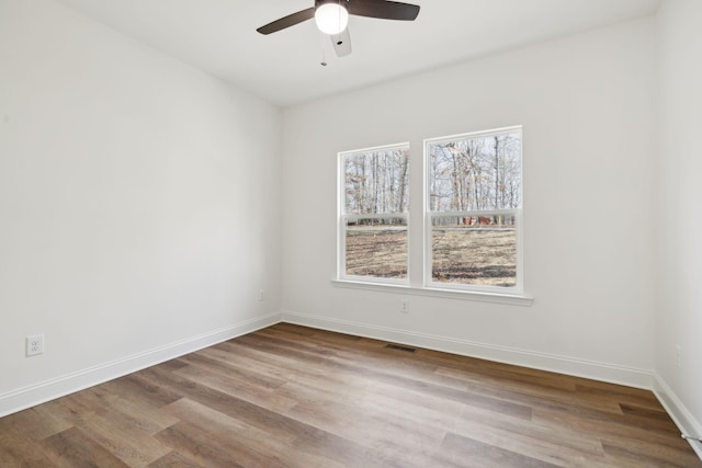 spare room featuring light wood-type flooring and ceiling fan