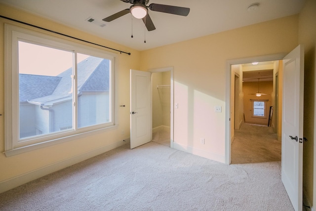 unfurnished bedroom with ceiling fan and light carpet