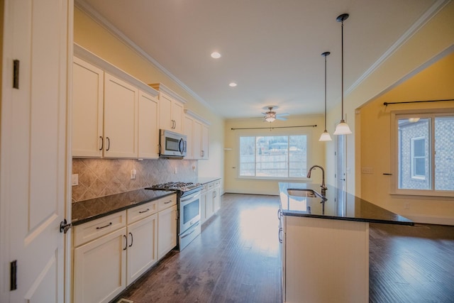 kitchen with white cabinetry, sink, a center island with sink, and appliances with stainless steel finishes