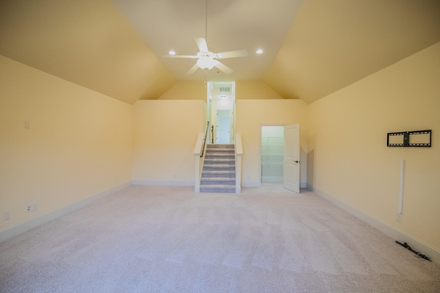 unfurnished living room featuring lofted ceiling, light colored carpet, and ceiling fan