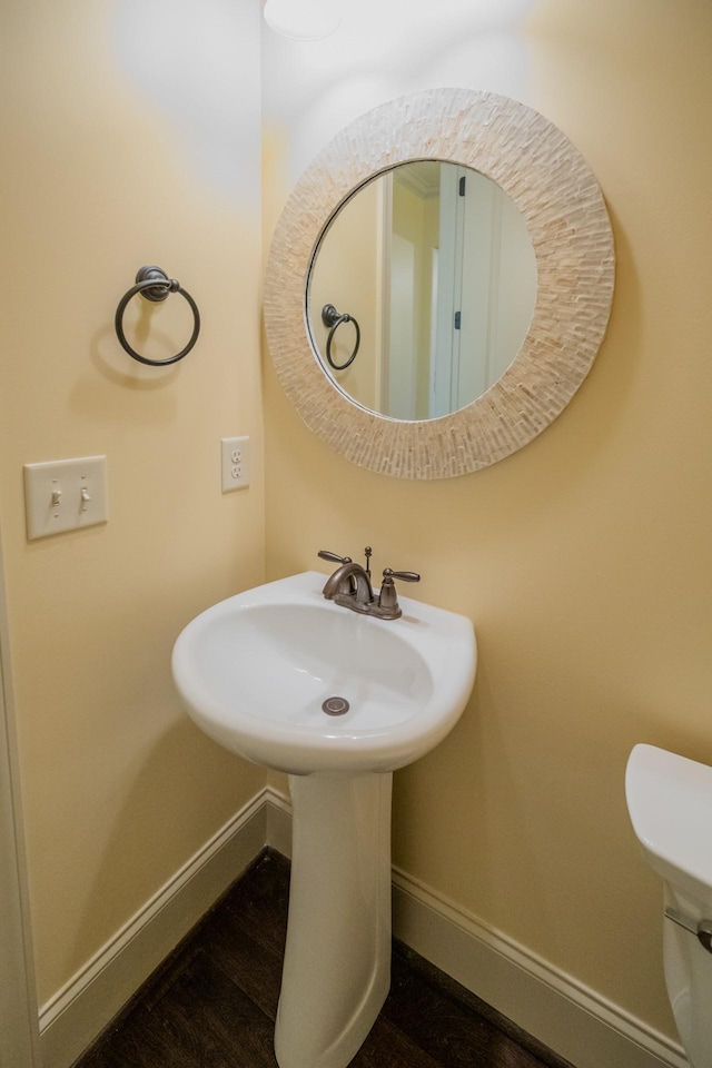 bathroom featuring sink, hardwood / wood-style floors, and toilet