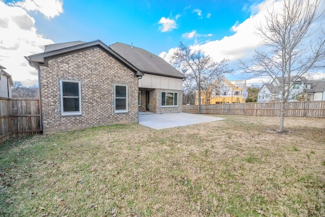 rear view of property featuring a patio area and a lawn