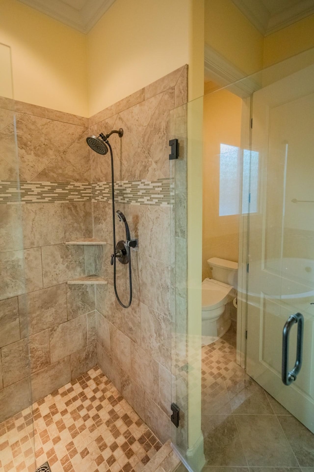 bathroom with crown molding, a shower with shower door, tile patterned floors, and toilet