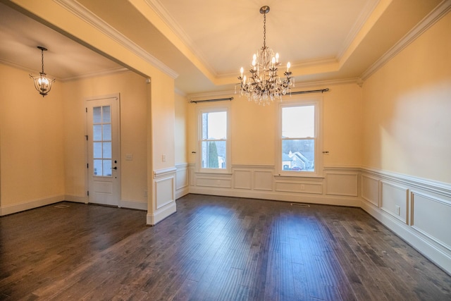 interior space featuring dark wood-type flooring, ornamental molding, a raised ceiling, and a notable chandelier