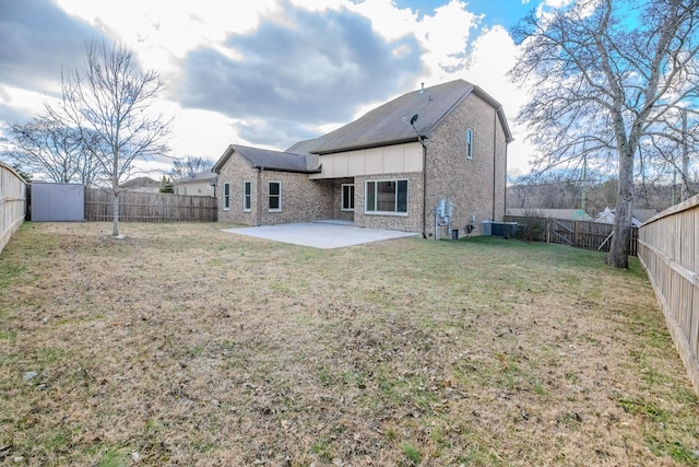 back of house featuring a patio and a lawn