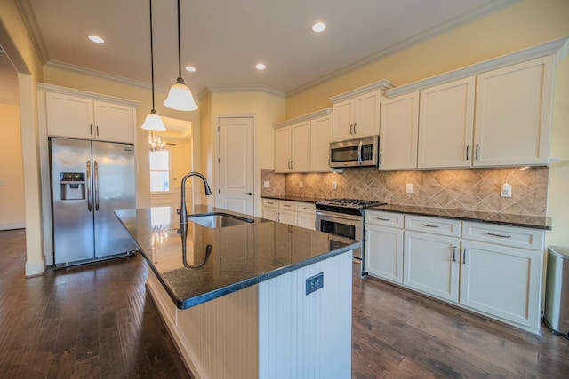 kitchen featuring hanging light fixtures, a center island with sink, white cabinets, and appliances with stainless steel finishes