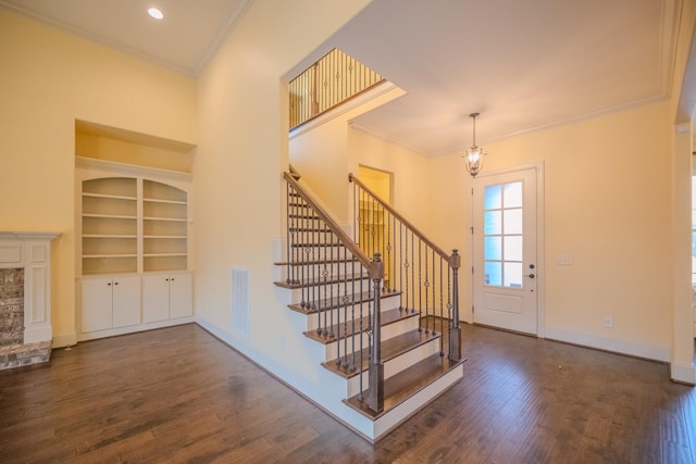 foyer featuring dark wood-type flooring and ornamental molding