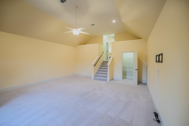 unfurnished living room with lofted ceiling, light colored carpet, and ceiling fan