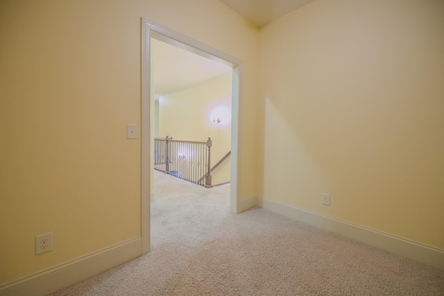 spare room featuring light colored carpet