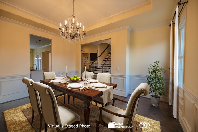 dining area featuring crown molding, a tray ceiling, a chandelier, and sink