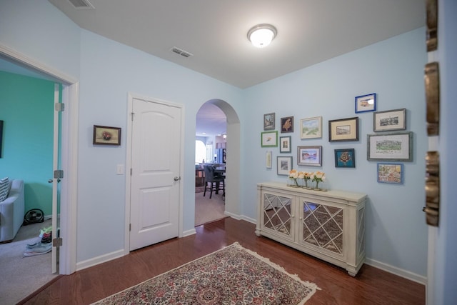 hallway featuring dark hardwood / wood-style flooring