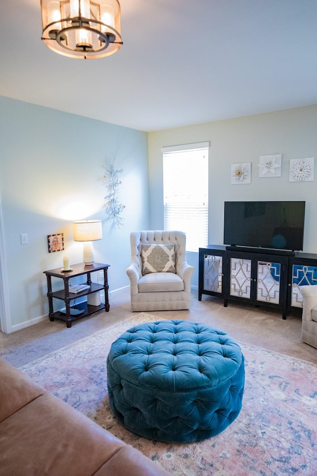 living room featuring carpet floors and a notable chandelier