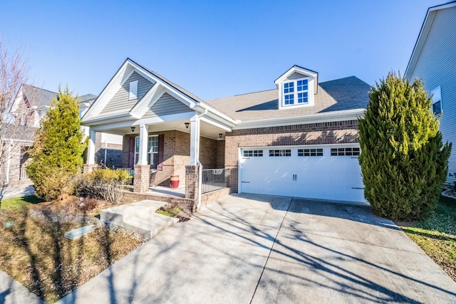 craftsman inspired home featuring a garage and a porch