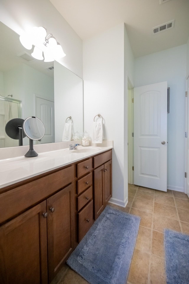 bathroom with vanity, tile patterned floors, and a shower with door