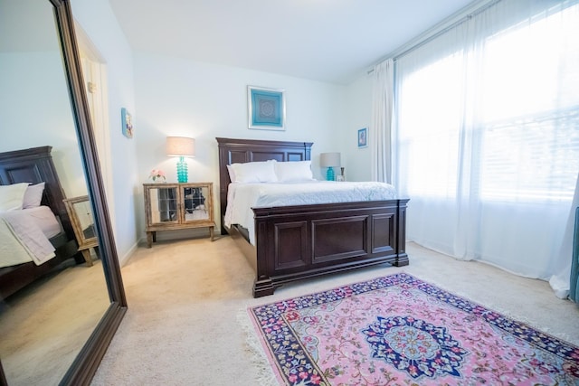 bedroom featuring light colored carpet