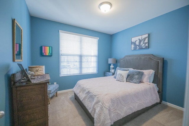 bedroom with multiple windows and light colored carpet