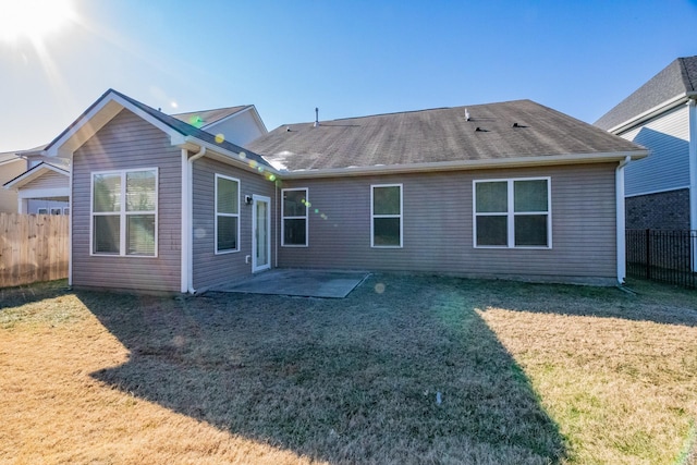 back of property featuring a patio area and a lawn