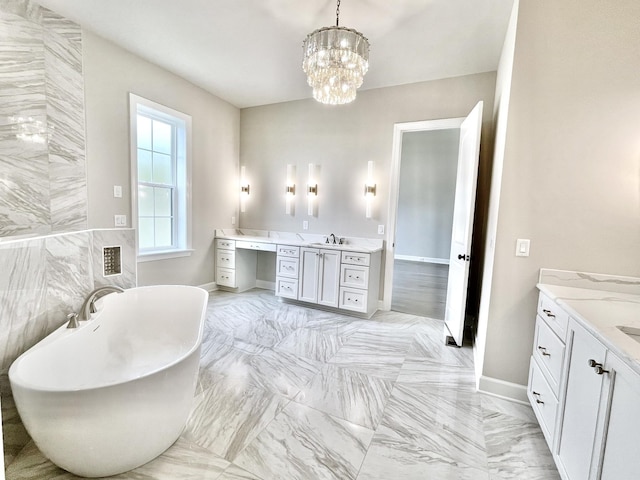 bathroom with a washtub, vanity, and a notable chandelier