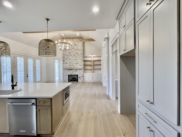 kitchen featuring light hardwood / wood-style floors, sink, built in shelves, pendant lighting, and gray cabinets