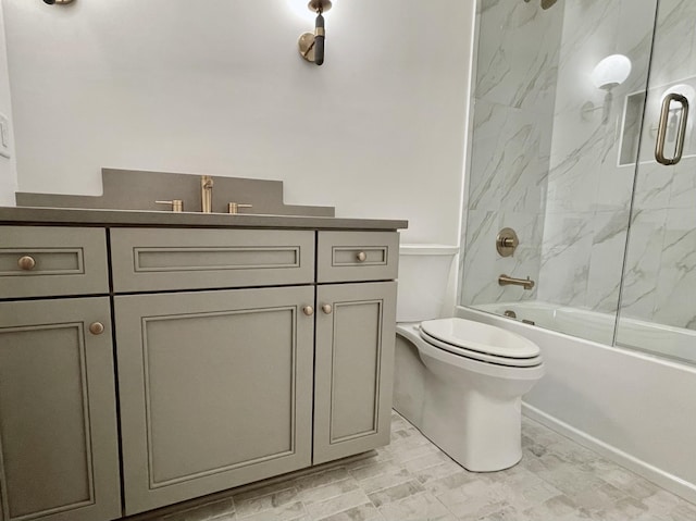 full bathroom featuring vanity, toilet, and combined bath / shower with glass door