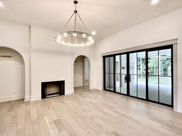 unfurnished living room with light wood-type flooring