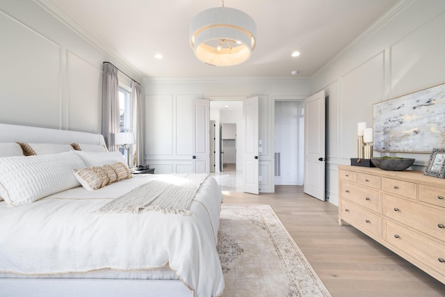 bedroom featuring light hardwood / wood-style floors and ornamental molding