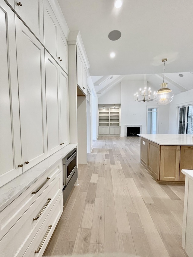 spacious closet featuring light hardwood / wood-style flooring and vaulted ceiling